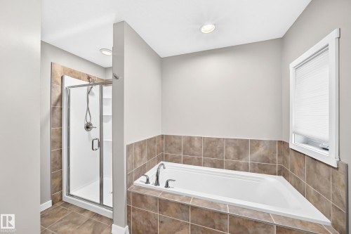 Walk-in shower with clear glass enclosure and integrated shelving - 3329 West Court Nw, Edmonton, AB 