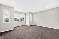 Bright, open room featuring multiple large windows with natural light, neutral wall finishes, and contemporary tile flooring in a geometric pattern - 
