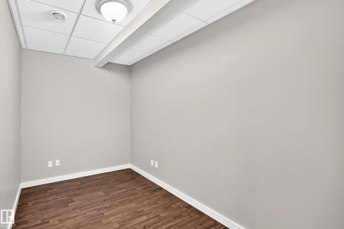 Wood-finish flooring, neutral wall tones, drop ceiling, flush mount lighting, recessed lighting - 3329 West Court Nw, Edmonton, AB 
