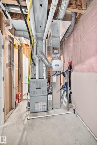 Concrete flooring and exposed ceiling utilities in an unfinished area - 3329 West Court Nw, Edmonton, AB 