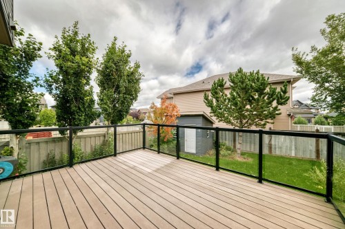 Spacious outdoor deck with composite decking and glass panel railings - 3329 West Court Nw, Edmonton, AB 