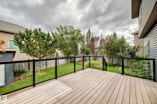 Expansive outdoor deck with composite decking and glass panel railings - 3329 West Court Nw, Edmonton, AB 