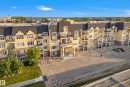Multi-story residential building with a yellow stucco exterior - #420 9820 165 St Nw, Edmonton, AB 