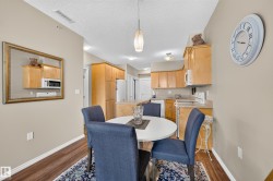 Kitchen featuring wood-finish cabinetry, light countertops, a built-in microwave, and a double basin sink - 