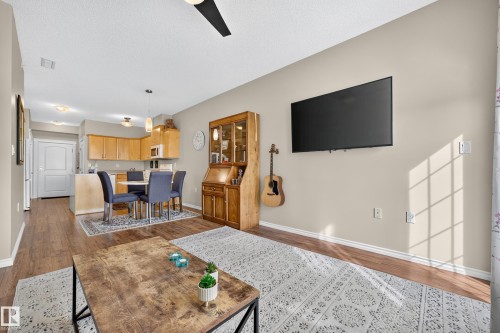 Wood-finish flooring throughout, light neutral wall tones, recessed lighting, and a ceiling fan - #420 9820 165 St Nw, Edmonton, AB 