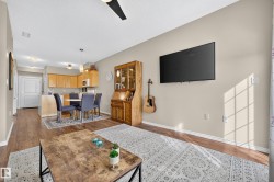Wood-finish flooring throughout, light neutral wall tones, recessed lighting, and a ceiling fan - 