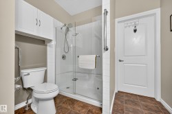Shower with glass enclosure, white subway tile surround, and grab bar - 