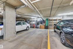 Concrete parking garage featuring designated parking spaces with yellow markings - 