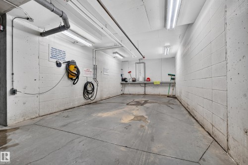 Concrete block walls with overhead fluorescent lighting - #420 9820 165 St Nw, Edmonton, AB 