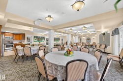 Expansive room featuring multiple round tables, patterned carpeting, and recessed ceiling lighting - 