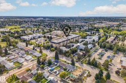 Aerial perspective showcasing a residential neighborhood with a mix of single-family homes and multi-story apartment buildings - 