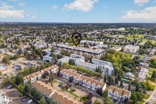 Aerial perspective showcasing the property within a tree-lined residential area - #420 9820 165 St Nw, Edmonton, AB 