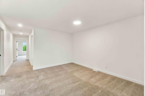 Recessed lighting, light-toned carpeting, white walls, white trim, and a round overhead light fixture - 5852 Raven Crescent Nw, Edmonton, AB 