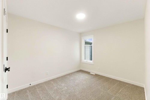 Neutral wall paint, recessed ceiling light, white window trim, and light-toned carpeting - 5852 Raven Crescent Nw, Edmonton, AB 