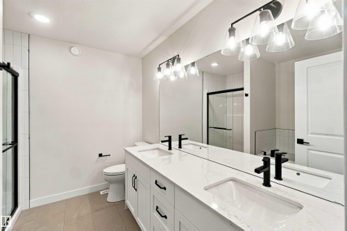 Dual vanity with integrated rectangular sinks and matte black fixtures - 5852 Raven Crescent Nw, Edmonton, AB 