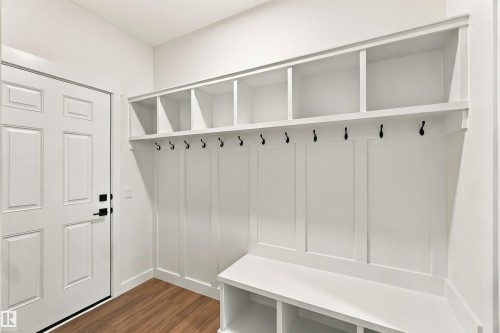 Built-in white storage system with hooks and open shelving - 5852 Raven Crescent Nw, Edmonton, AB 
