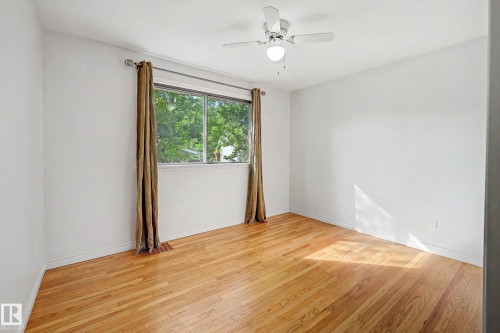 Wood-finish flooring with white walls - 10830 138 Street Nw, Edmonton, AB 