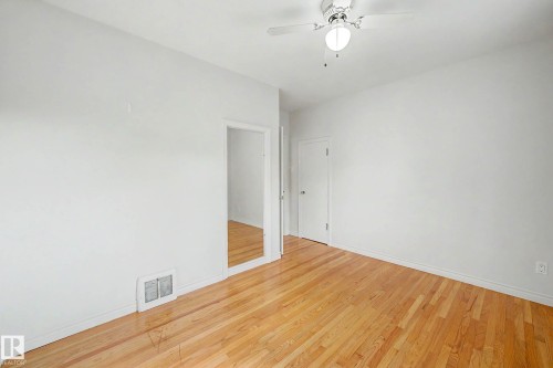 Hardwood flooring, white painted walls, ceiling fan, white trim, recessed doorway - 10830 138 Street Nw, Edmonton, AB 