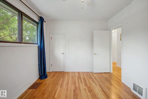 Hardwood flooring, white painted walls, ceiling fan, white interior doors - 10830 138 Street Nw, Edmonton, AB 