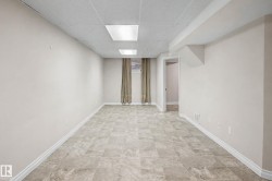 Spacious room featuring light-colored flooring, neutral wall paint, and recessed ceiling lighting - 