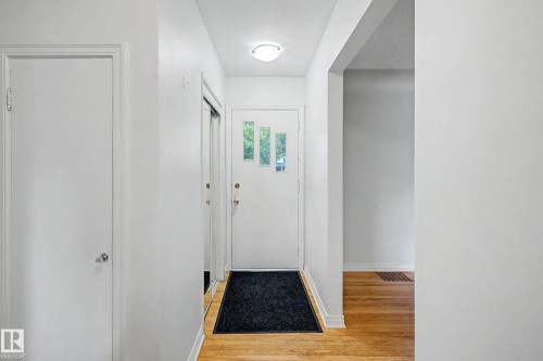 Wood-finish flooring throughout the entry - 10830 138 Street Nw, Edmonton, AB 