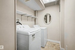 Dedicated laundry area featuring a skylight, overhead shelving, and a neutral color palette - 