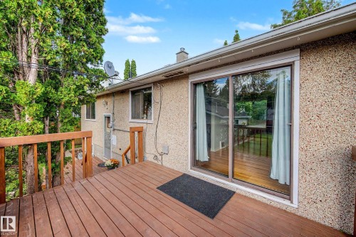 Expansive wood deck with a full-height railing - 10830 138 Street Nw, Edmonton, AB 