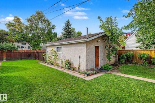 Detached outbuilding with an exterior door, a window, and a garden bed - 10830 138 Street Nw, Edmonton, AB 