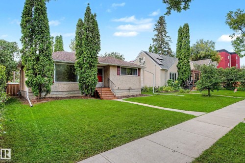 Stucco exterior with a peaked roof and prominent front window - 10830 138 Street Nw, Edmonton, AB 