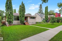 Stucco exterior with a peaked roof and prominent front window - 