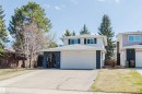 Two-story facade with white siding and dark gray brick detailing - 10423 35 Avenue Nw, Edmonton, AB 
