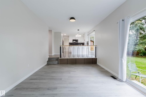 Light wood-finish flooring with white walls - 10423 35 Avenue Nw, Edmonton, AB 