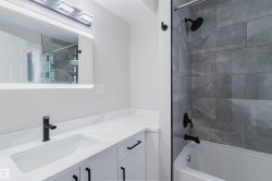 White vanity with matte black hardware, integrated sink, and white countertop - 