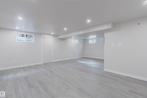 Expansive room featuring recessed lighting, light-toned wood-finish flooring, and white walls - 10423 35 Avenue Nw, Edmonton, AB 