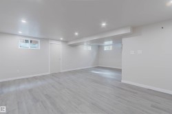 Expansive room featuring recessed lighting, light-toned wood-finish flooring, and white walls - 