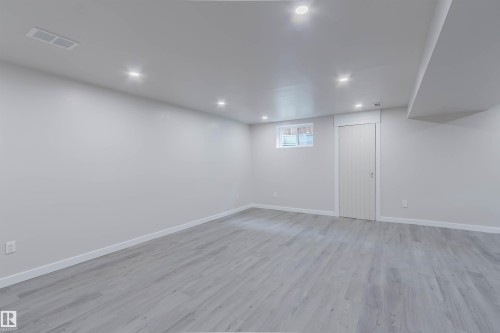 Recessed lighting with a drop ceiling, light wood-finish flooring, and white trim - 10423 35 Avenue Nw, Edmonton, AB 