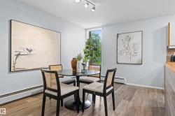 Recessed lighting fixtures illuminate the space, featuring wood-finish flooring and a window offering exterior greenery - 