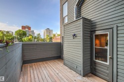 Private outdoor deck with wood flooring and horizontal slat privacy walls - 