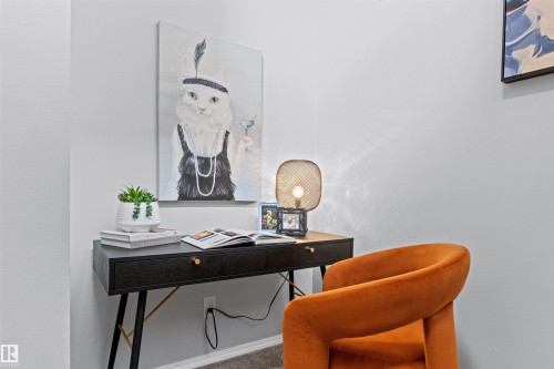 Built-in desk with a black finish, gold-toned drawer pull, and coordinating metal legs - #7 10032 113 St Nw, Edmonton, AB 