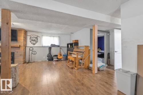 Wood-finish flooring throughout the space - 8808 43 Avenue Nw, Edmonton, AB 