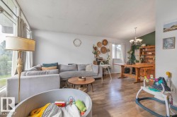 Wood-finish flooring throughout, bright window, and a built-in chandelier - 