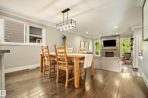 Open-concept living area with dark wood-finish flooring, recessed lighting, and crown molding - 11 Brunswick Crescent, St. Albert, AB 