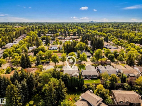 Residential neighborhood with mature tree canopy and distant urban skyline - 11 Brunswick Crescent, St. Albert, AB 