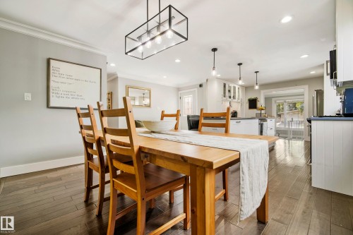 Wood-finish flooring throughout, crown molding, recessed lighting, and a modern rectangular chandelier - 11 Brunswick Crescent, St. Albert, AB 