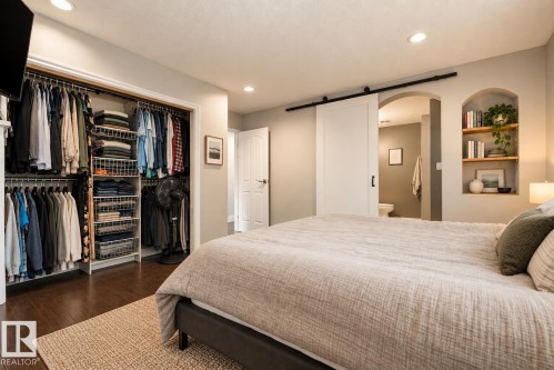 Custom closet organization system, wood-finish flooring, recessed lighting, barn door entry, and built-in arched shelving - 11 Brunswick Crescent, St. Albert, AB 