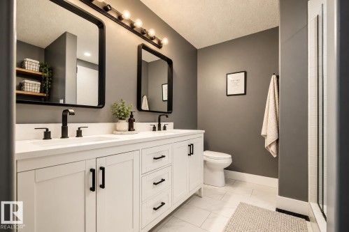 Dual vanity with quartz countertops, matte black fixtures, and shaker-style cabinetry - 11 Brunswick Crescent, St. Albert, AB 