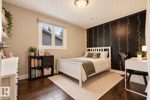 Dark wood-finish flooring, a contemporary window, recessed ceiling lighting, and a built-in shelving unit - 11 Brunswick Crescent, St. Albert, AB 
