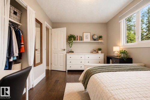 Wood-finish flooring, white trim, and a four-panel interior door - 11 Brunswick Crescent, St. Albert, AB 