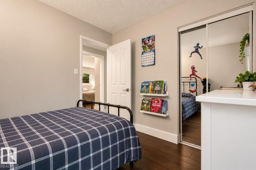 Mirrored sliding closet doors, wood-finish flooring, and light neutral wall paint - 11 Brunswick Crescent, St. Albert, AB 