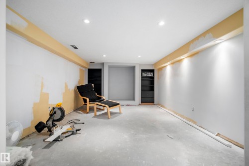 Recessed ceiling lighting, built-in wall shelving, and exposed concrete flooring - 11 Brunswick Crescent, St. Albert, AB 